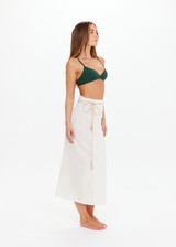 THE UPSIDE women's cream Beach Serenade Wrap Sarong is made from cotton. The beach sarong skirt features vegan leather braided belt. Designed for layering and travel.