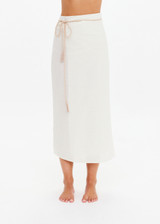 THE UPSIDE women's cream Beach Serenade Wrap Sarong is made from cotton. The beach sarong skirt features vegan leather braided belt. Designed for layering and travel.