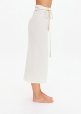THE UPSIDE women's cream Beach Serenade Wrap Sarong is made from cotton. The beach sarong skirt features vegan leather braided belt. Designed for layering and travel.
