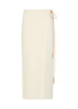 THE UPSIDE women's cream Beach Serenade Wrap Sarong is made from cotton. The beach sarong skirt features vegan leather braided belt. Designed for layering and travel.
