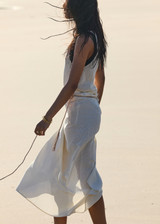 THE UPSIDE women's cream Beach Serenade Wrap Sarong is made from cotton. The beach sarong skirt features vegan leather braided belt. Designed for layering and travel.