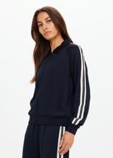 THE UPSIDE women's black Empire Pari Zip Jacket fits true-to-size and features a zip-through opening and knitted cream stripes down sides with a hint of silver metallic. Made for lifestyle.