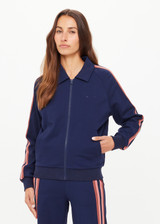THE UPSIDE women’s navy Ananda Pari Zip Jacket is a true-to-size fit and features a zip-through front, front pockets and knitted stripes down sleeves. The perfect everyday piece.