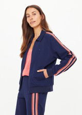 THE UPSIDE women’s navy Ananda Pari Zip Jacket is a true-to-size fit and features a zip-through front, front pockets and knitted stripes down sleeves. The perfect everyday piece.