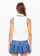 THE UPSIDE women’s white Henri Collared Top, in a cotton pique fabrication, features buttons at the front neck with a ribbed collar in a navy stripe. Designed for tennis.
