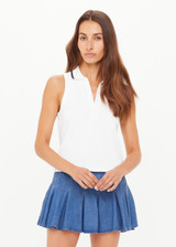 THE UPSIDE women’s white Henri Collared Top, in a cotton pique fabrication, features buttons at the front neck with a ribbed collar in a navy stripe. Designed for tennis.