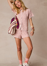 THE UPSIDE women's pink organic cotton Anoki Malik Crochet Short features an elastic waist with tassel braided drawcord and cream scalloped edge detailing. Perfect for travel or everyday.