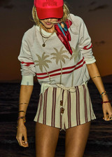 THE UPSIDE women's stripe organic cotton Baja Lucie Drawstring Short has a low-rise cheeky fit, soft elastic waistband, and wooden bead ends on the drawcord. Made for lifestyle.