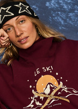 THE UPSIDE women’s maroon organic cotton Le Ski Clementine Crew is designed for an oversized fit and features Le Ski logo print & embroidery on front chest. Designed for Après-ski and winter wear.