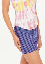 THE UPSIDE women's tie-dye organic cotton Asher Racerback Tank Top features hand tie-dyed tropical shades of pink, red, and yellow on a white base. Made for lifestyle.