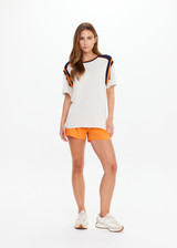 THE UPSIDE women’s cream cotton Elixir Seven Tee is designed for a relaxed fit and features orange and navy stripes on neckline and shoulders. Made for everyday wear.