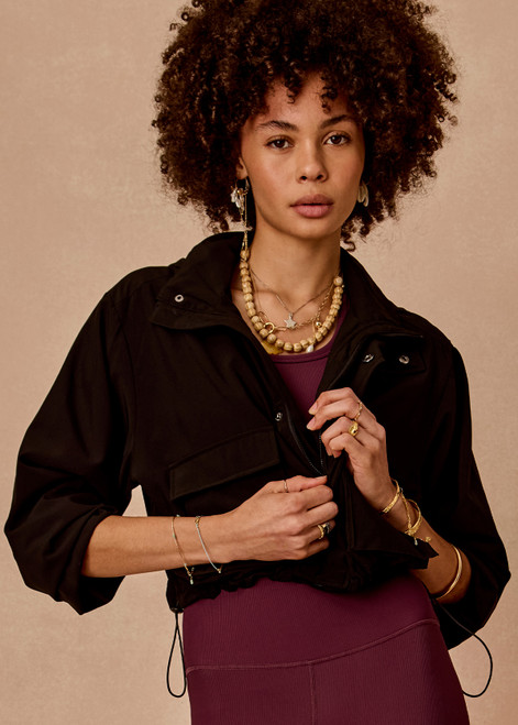 THE UPSIDE women's black Ace Shell Jacket is a water-resistant cropped zip-through jacket and features front pockets and an adjustable drawcord at waist. Made for running.