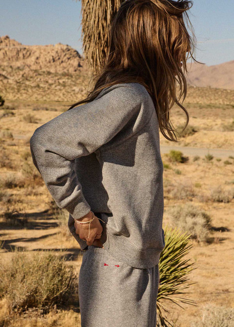 THE UPSIDE women's grey cotton Hit The Road Track Top is a relaxed raglan crew neck sweater in french terry fabrication with a ribbed neckline, arms and cuffs. Made for lifestyle.
