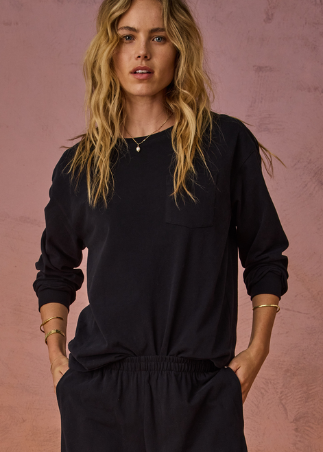 THE UPSIDE women's black recycled cotton Soho Cara Long Sleeve Top is designed for a relaxed fit and features a ribbed neck and cuffs and a patch pocket at front. Made for everyday leisure.