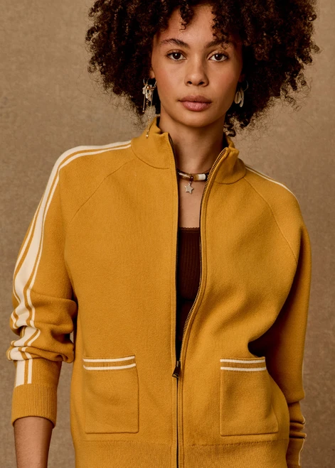 THE UPSIDE women's yellow organic cotton Bonito Dylan Knit Jacket offers a relaxed fit and features raglan sleeves, front patch pockets and contrast stripe detailing. Made for lifestyle.