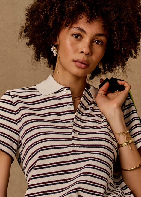 THE UPSIDE women's stripe organic cotton Sophie Cropped Polo Shirt is designed for a cropped fit and features a collared neckline, button front closure and adjustable drawcord hem detailing. Made for lifestyle.