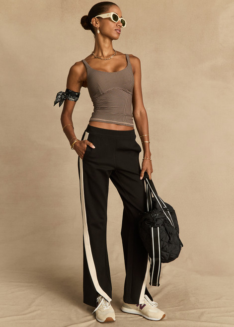 THE UPSIDE women's black Petra Flare is made from a lenzing viscose soft suiting fabrication. The full length tailored pant features side pockets and an elasticated waistband. Designed for walking and recovery.