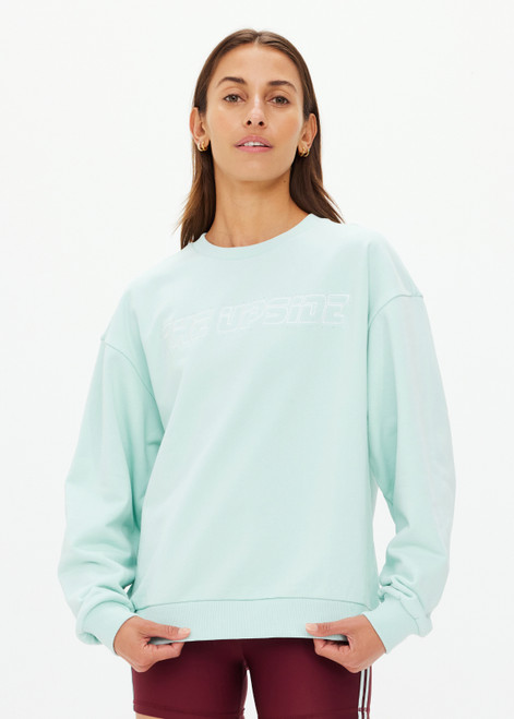 THE UPSIDE women's mint organic cotton Stardust Saturn Crew is designed for a oversized fit and features an embroidered The Upside logo at front with subtle rhinestone detailing.