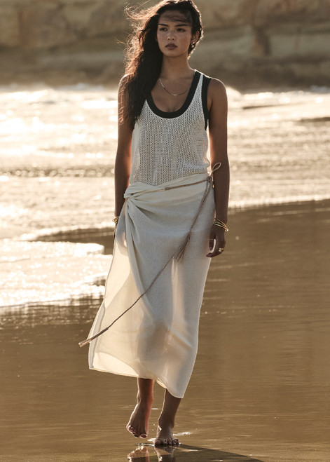 THE UPSIDE women's cream Beach Serenade Wrap Sarong is made from cotton. The beach sarong skirt features vegan leather braided belt. Designed for layering and travel.