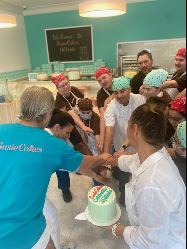 Team huddle in a bakery.