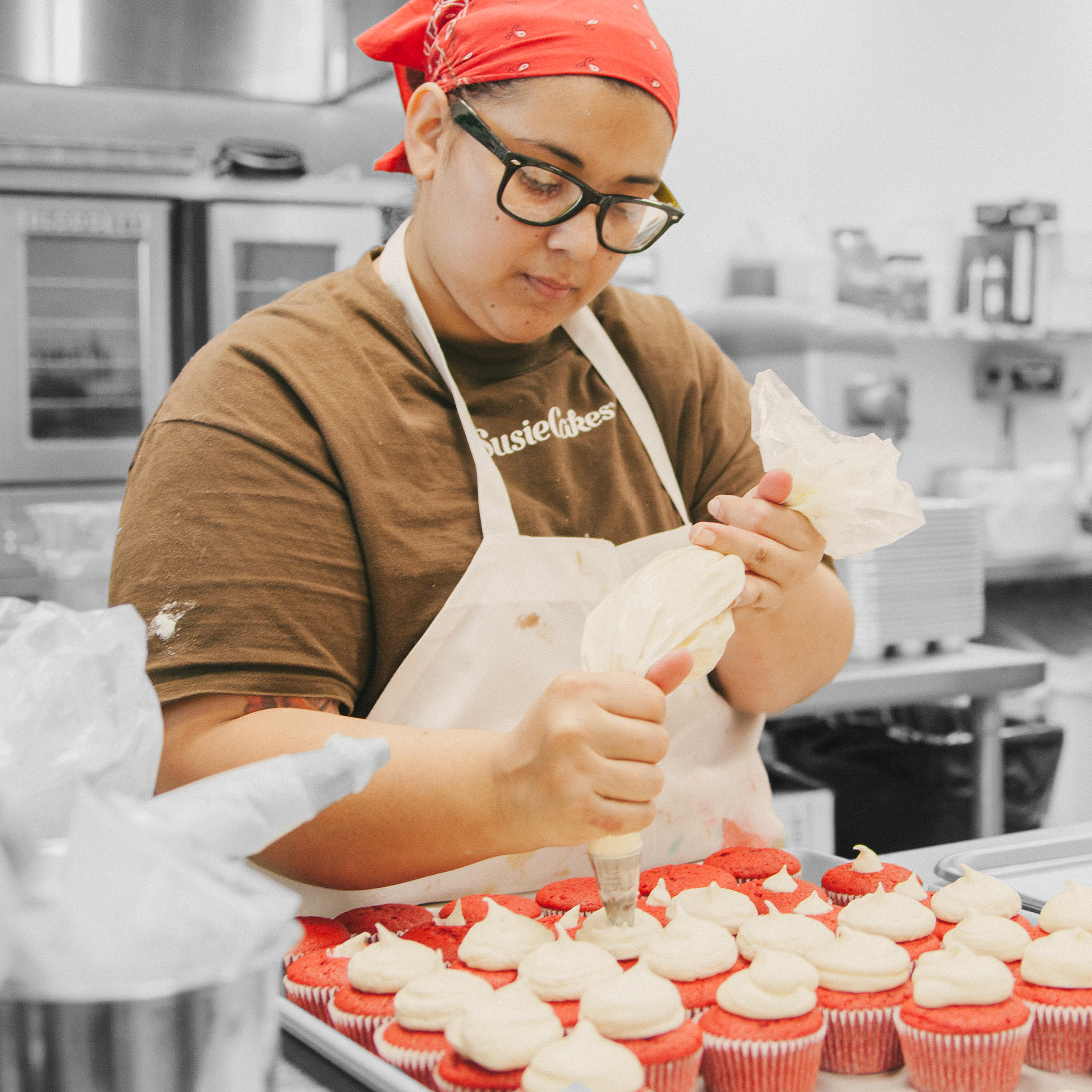 Team Member Piping Cupcakes