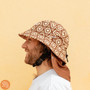 Plow Surf Co. | Bloomin Groover | Plow Surf Hat | Surfing Hat | Beach + Water Activity Headwear. Man wearing with yellow background 