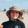 Plow Surf Co. | Bloomin Groover | Plow Surf Hat | Surfing Hat | Beach + Water Activity Headwear. Child wearing with beach in the background