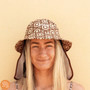 Plow Surf Co. | Bloomin Groover | Plow Surf Hat | Surfing Hat | Beach + Water Activity Headwear. Lady wearing with yellow background 