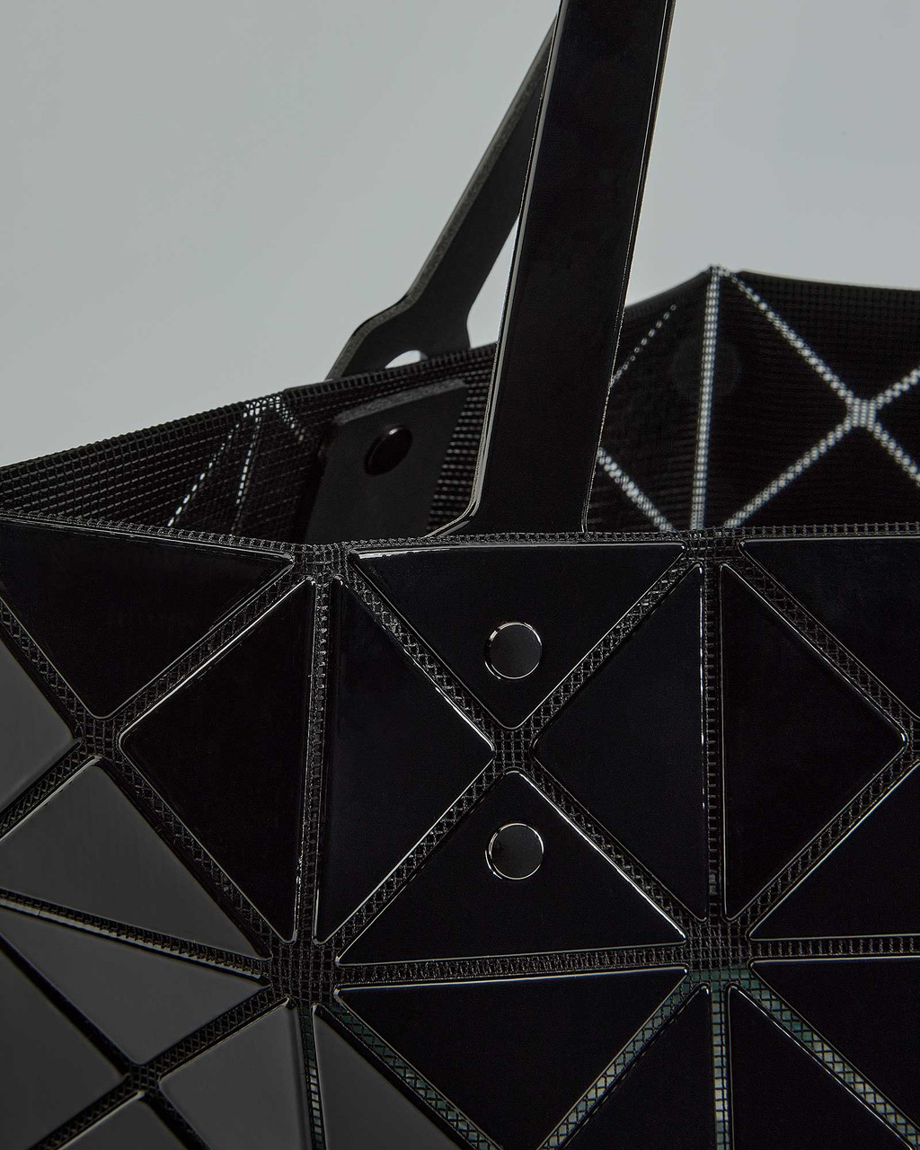 Adjustable handles on Bao Bao Issey Miyake tote shown for versatile carrying. View Product Image