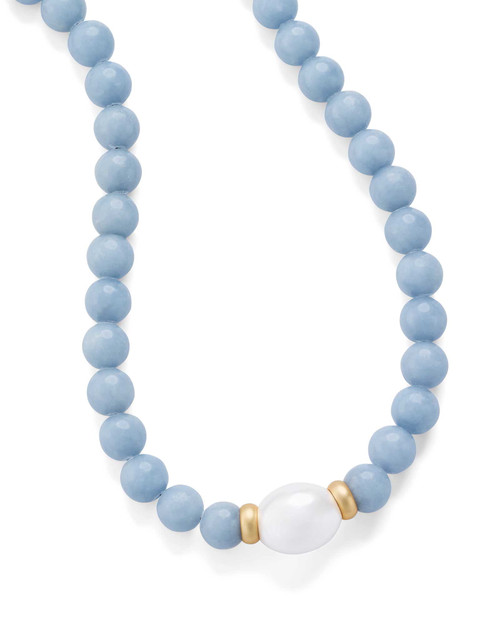 Detailed view of a mother-of-pearl bead framed in angelite jewelry with matte gold accents.