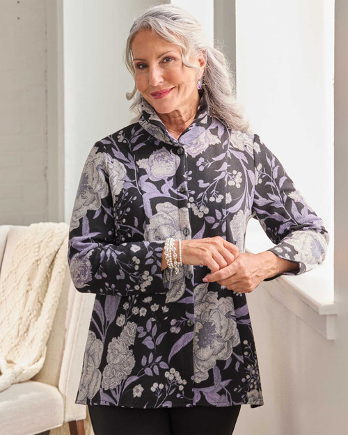 Woman modeling the botanical jacket, showing its flattering A-line fit and floral detailing. View Product Image
