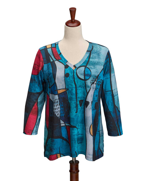 Colorful graphic V-neck showcasing abstract patterns in blue, red, and black on a mannequin.