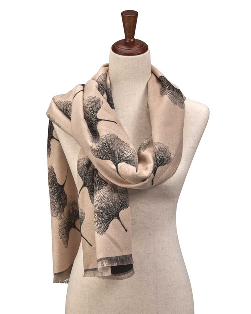 White reversible scarf with black ginkgo leaf pattern draped on a mannequin.