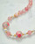 Close detail of lacquered tensha beads inspired by traditional Japanese artistry. View Product Image