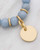 Blue bracelet charm shown in close-up, revealing the hammered texture of the gold-plated accent. View Product Image