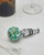 Green Murano glass bottle stopper laying on a white surface. View Product Image