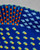 Detailed view of colorful raised dots on a hand-painted ceramic serving platter. View Product Image