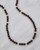 Garnet beads necklace laid in a curve to highlight length and color. View Product Image