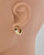 Modeled view of garnet hoop earrings highlighting the elegant fit. View Product Image