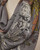Charcoal floral scarf close-up emphasizing layered botanical designs. View Product Image