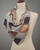 Silk scarf square shown from the side on a mannequin in silver tones. View Product Image
