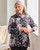 Woman modeling the botanical jacket, showing its flattering A-line fit and floral detailing. View Product Image
