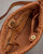 Interior of brown Italian soft leather bag shown with organized storage. View Product Image