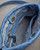 Blue drawstring leather purse interior featuring spacious compartments. View Product Image