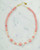 Handcrafted Japanese bead necklace showcasing pink tensha beads and warm gold tones. View Product Image