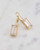 White topaz earrings featuring baguette-shaped stones and gold-plated bezel settings. View Product Image
