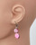 Close-up of berry pink mother-of-pearl earrings showing subtle color variations. View Product Image