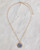 A stylish necklace with a gold chain with a blue crystal pave pendant. View Product Image