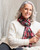 Model wearing an oblong silk scarf with a Christmas pattern. View Product Image