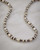 Handmade silver rice bead necklace, featuring diminutive sterling beads on a 36 inch strand with a spring ring clasp. View Product Image